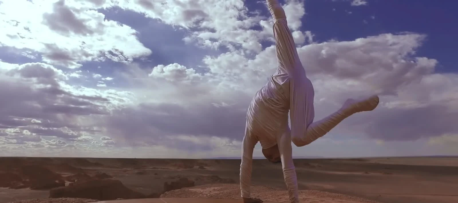 Ochir hand balancing beneath a vast sky in Mongolia